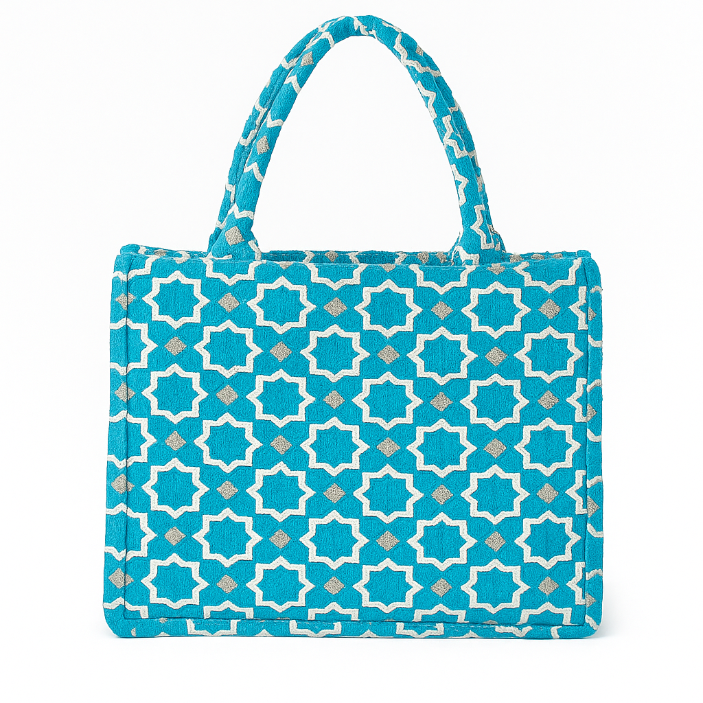 Azure Medina Tote Bag. Moroccan velvet brocade handbag with white star motifs, padded handles, and structured silhouette