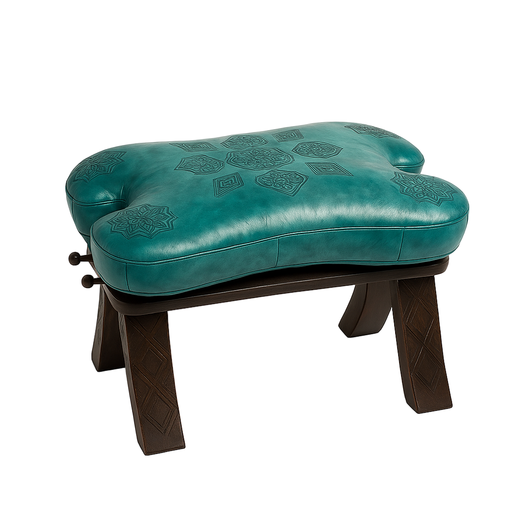 Moroccan stool with turquoise embossed leather cushion and dark carved wooden legs, handmade by artisans in Morocco.
