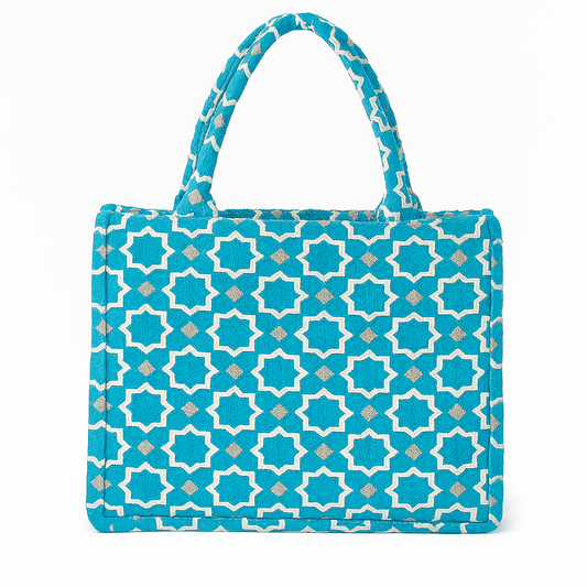 Azure Medina Tote Bag. Moroccan velvet brocade handbag with white star motifs, padded handles, and structured silhouette
