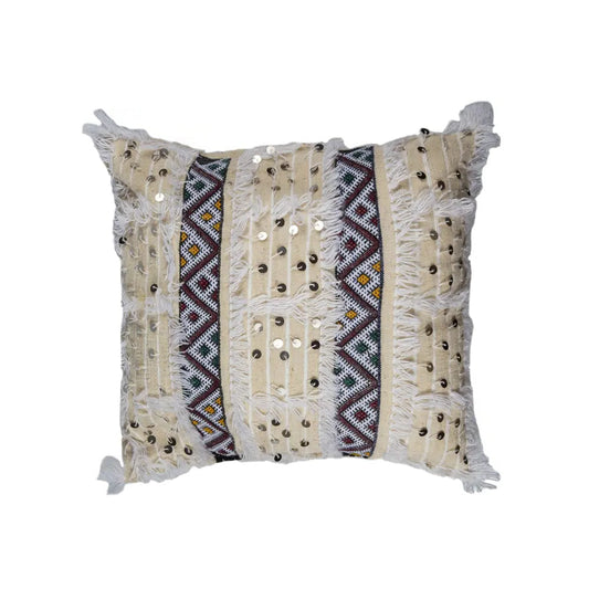 Beige Moroccan Handira pillow cover with multicolor Berber embroidery, white fringe, and silver sequins, handcrafted from wool and cotton.
