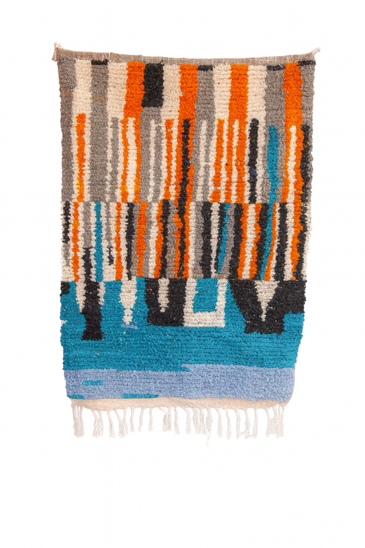 Handwoven Beni Ourain mini rug with amber, aqua, grey, and charcoal vertical color block pattern.
