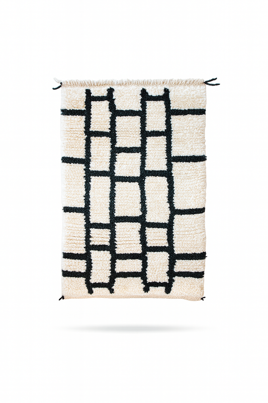 Handwoven Beni Ourain mini rug with ivory wool base and bold black gridline pattern.
