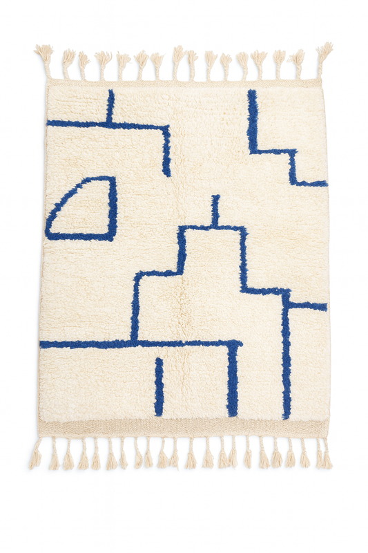 Handwoven Beni Ourain mini rug with ivory base and deep blue maze style line pattern.
