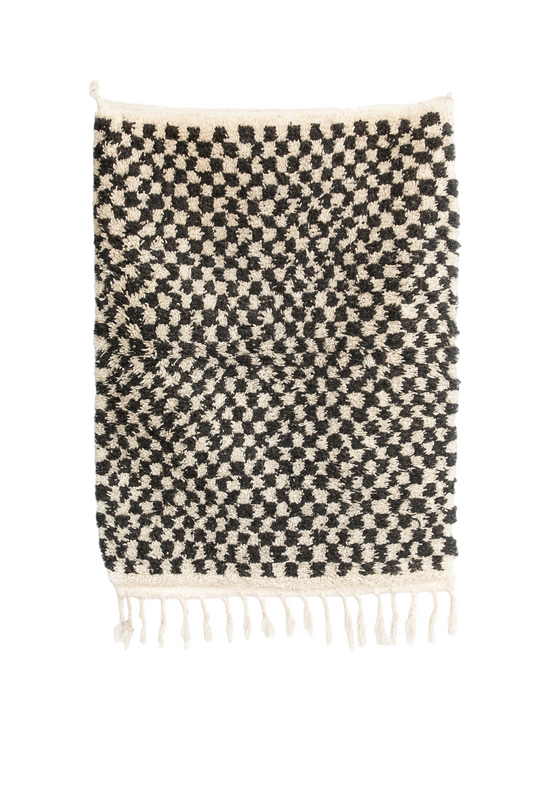Handwoven Beni Ourain mini rug with black and ivory vortex checker pattern.