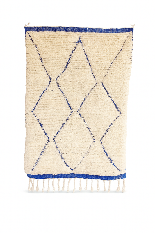 Handwoven Beni Ourain mini rug with ivory base and blue diamond pattern.