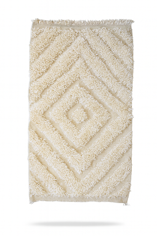Handwoven Beni Ourain mini rug in ivory wool with raised diamond texture.
