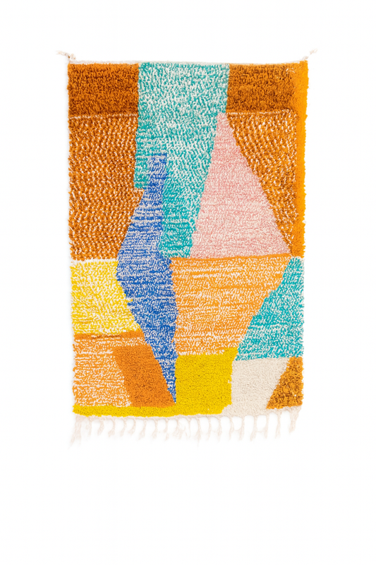 Handwoven Beni Ourain mini rug with bold geometric blocks in mustard, teal, sky blue, burnt orange, terracotta, pink, and ivory.
