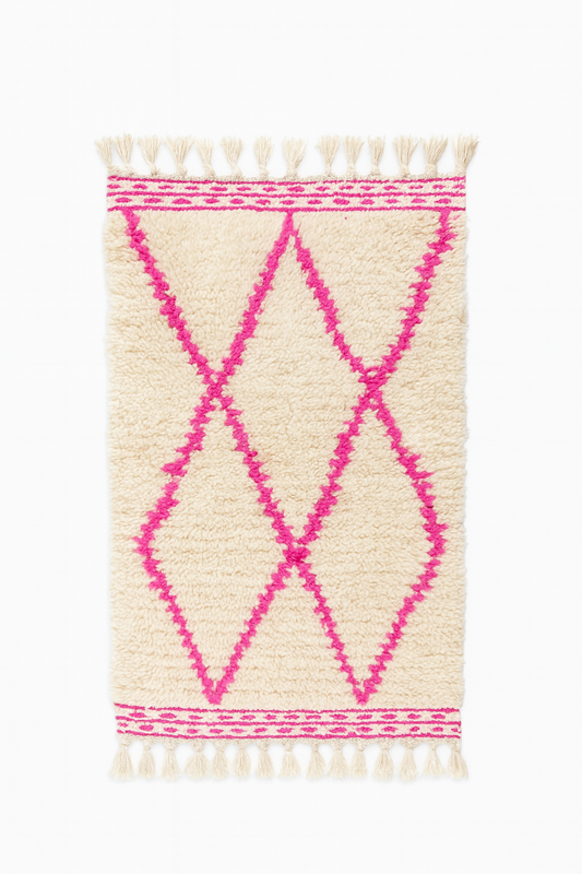Handwoven Beni Ourain mini rug in ivory wool with bright pink diamond lines.
