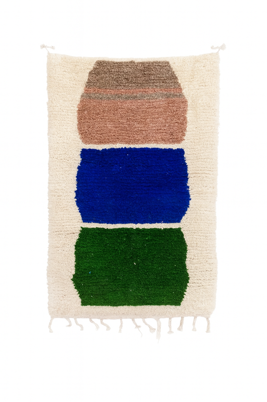 Handwoven Beni Ourain mini rug with terracotta, cobalt blue, and green color-block design on an ivory wool base.