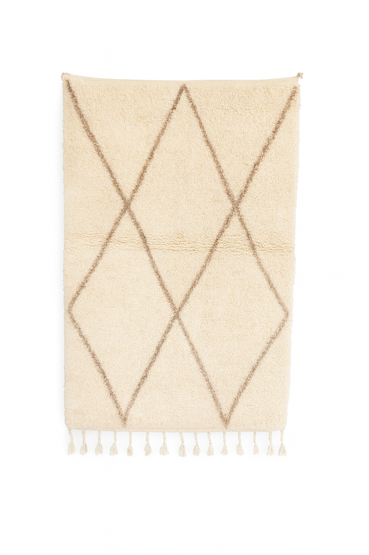 Handwoven Boujad mini rug with ivory base and sandy beige diamond pattern.
