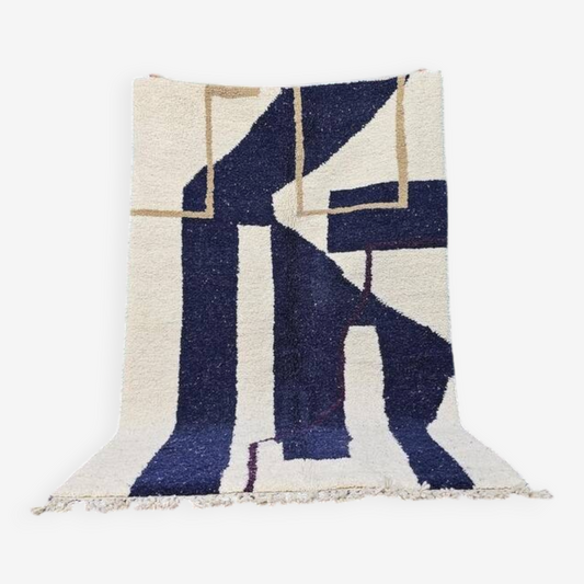 Geometric patterned rug with blue, beige, and white colors on a white background