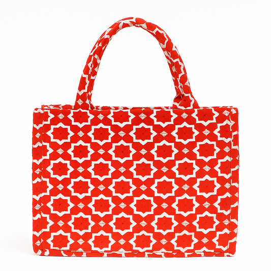Red velvet Moroccan tote bag with ivory star tilework pattern and padded handles.
