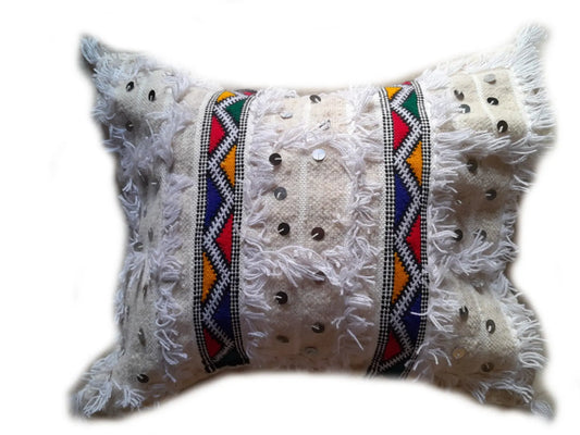 White Moroccan Handira pillow cover with colorful Berber embroidery, fringe texture, and silver sequins, handmade from wool and cotton